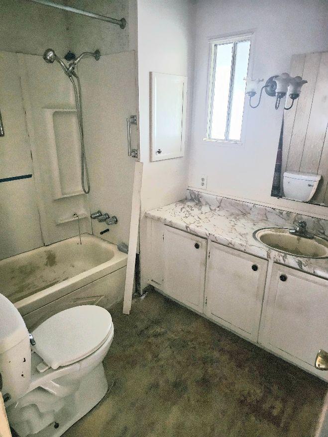 8665 Florin Road, Unit 109 Sacramento, CA 95828 - Photo 18 of 18 a bathroom with a granite countertop toilet a sink and bathtub