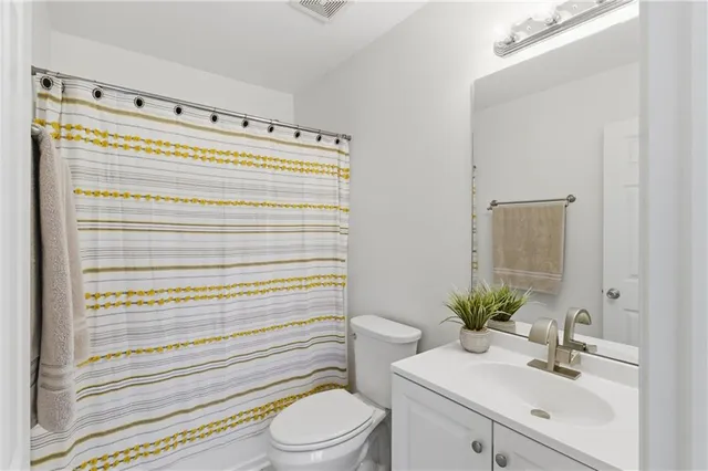 a bathroom with a sink a toilet and vanity