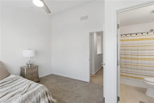 a bedroom with a bed and a lamp on table