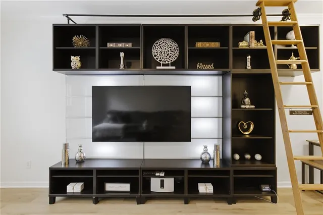 a living room with a table and a fireplace