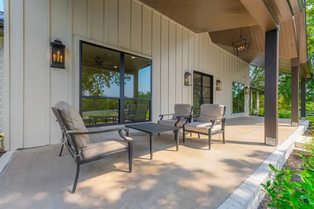 a building outdoor space with patio furniture and potted plants