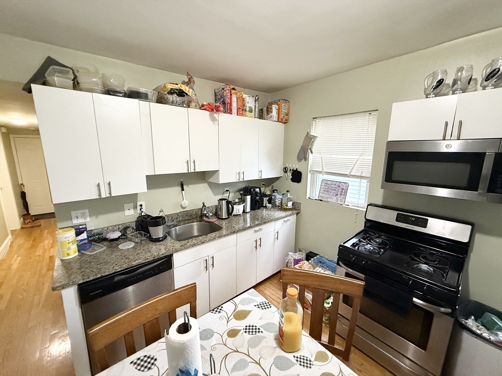 a kitchen with a stove a sink and a microwave