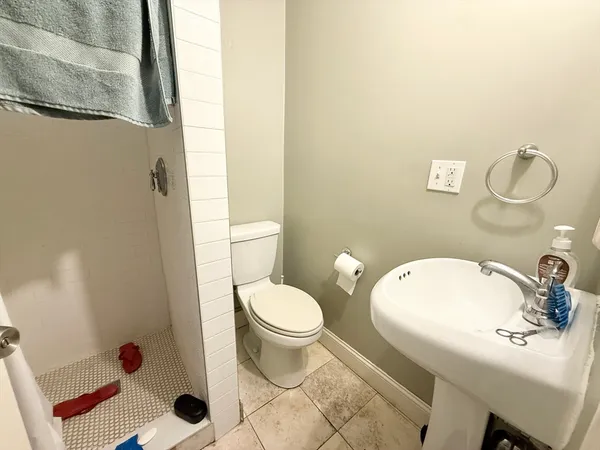 a bathroom with a sink toilet and shower