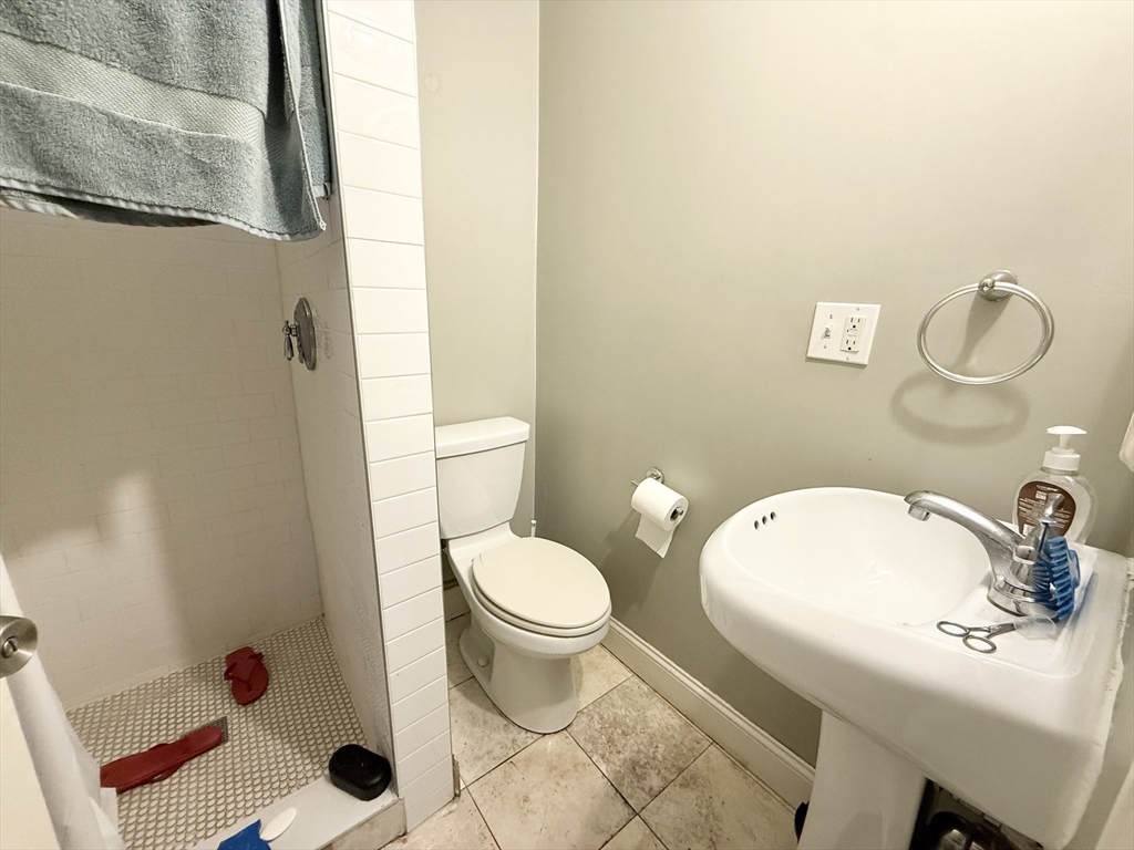 3977 Washington Street, Unit 1 Boston, MA 02131 - Photo 12 of 13 a bathroom with a sink toilet and shower