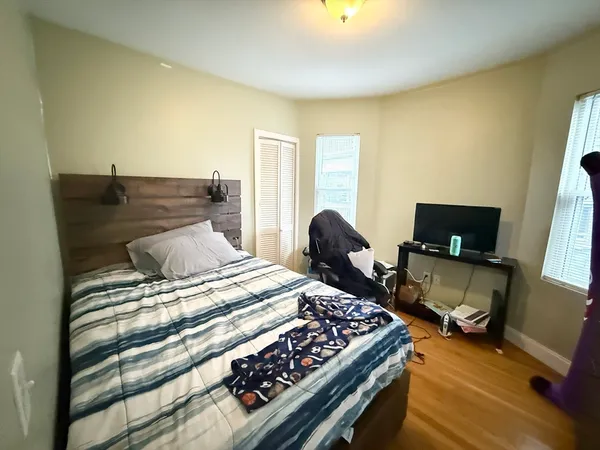 a bedroom with a bed and a chair