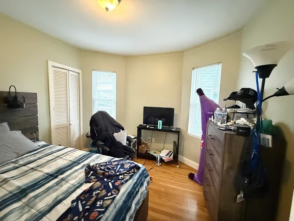 a bedroom with a bed and a tv