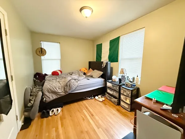 a bed room with a bed and a chair