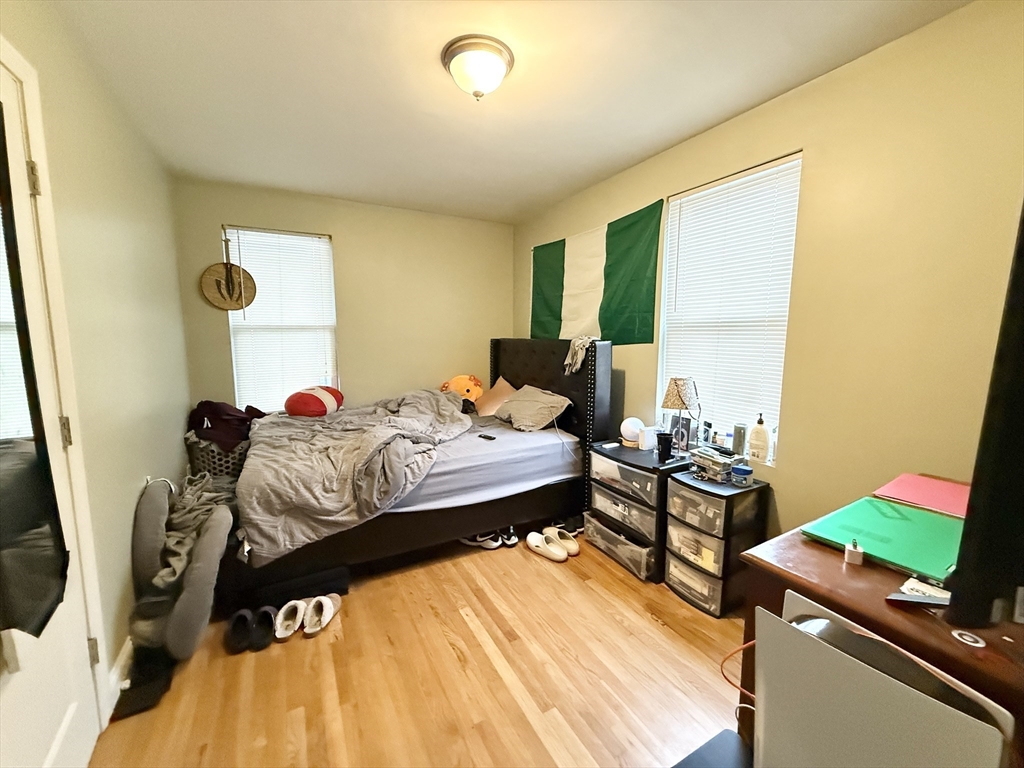 3977 Washington Street, Unit 1 Boston, MA 02131 - Photo 10 of 13 a bed room with a bed and a chair