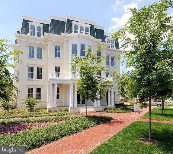 910 Powhatan Street, Unit 105N Alexandria, VA 22314 - Photo 1 of 1 a front view of a residential apartment building with a yard