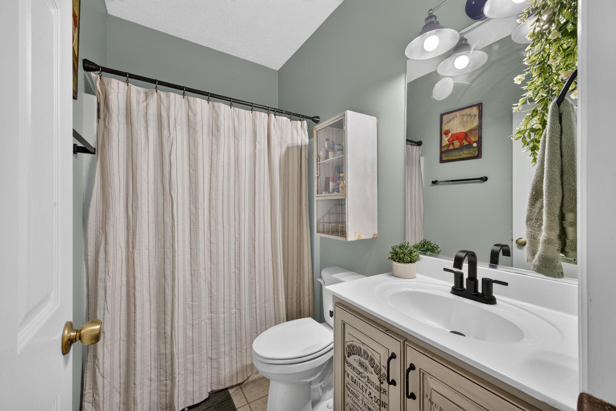 42 Emerald Ridge Aiken, SC 29803 - Photo 14 of 33 a bathroom with a sink a toilet and shower curtain