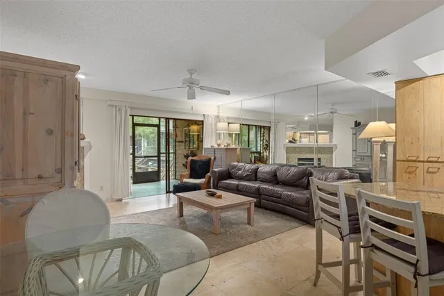 a kitchen with stainless steel appliances granite countertop a refrigerator a sink dishwasher a stove and white countertops with cabinets