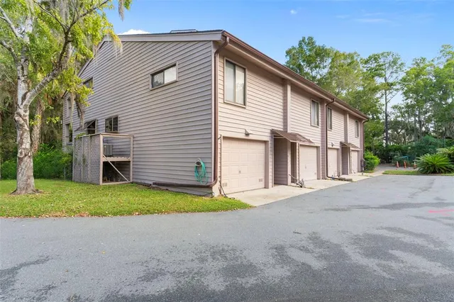 a view of a house with a yard and large garage