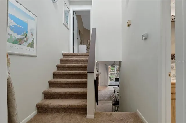 a spacious bedroom with a bed and a chandelier