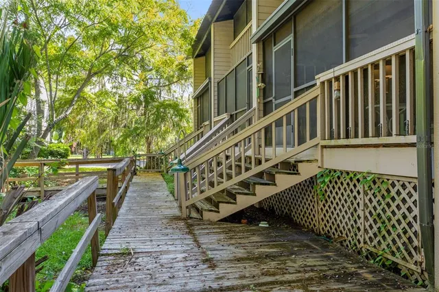 a front view of a house with a yard and potted plants