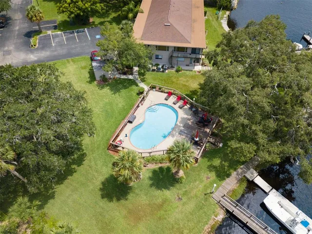 an aerial view of a house with a yard basket ball court and outdoor seating