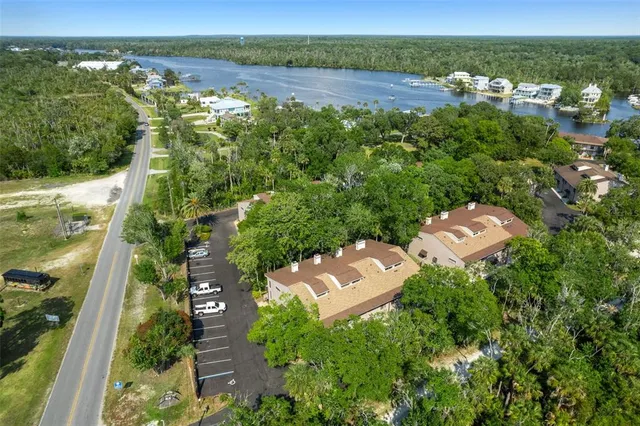 an aerial view of a city with lots of residential buildings ocean and mountain view in back
