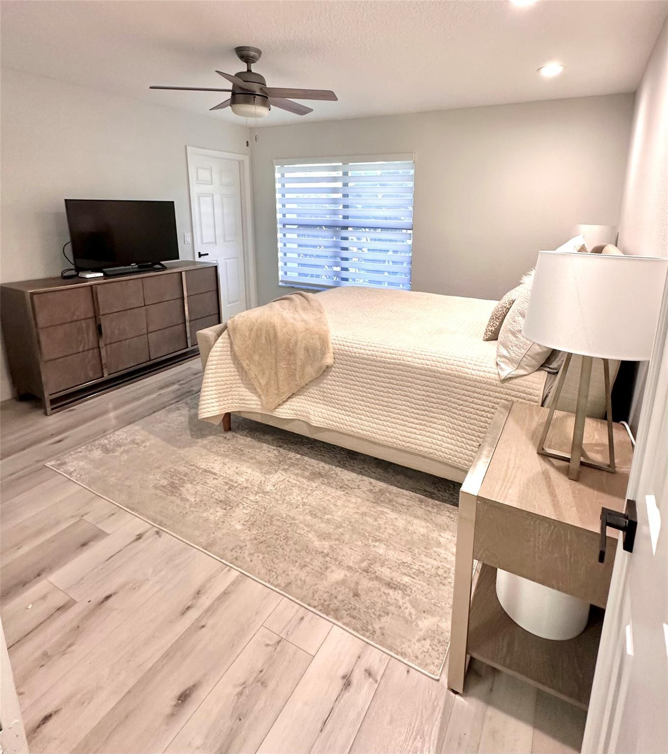 11392 Boca Woods Lane Boca Raton, FL 33428 - Photo 16 of 26 a bedroom with a bed and a flat screen tv
