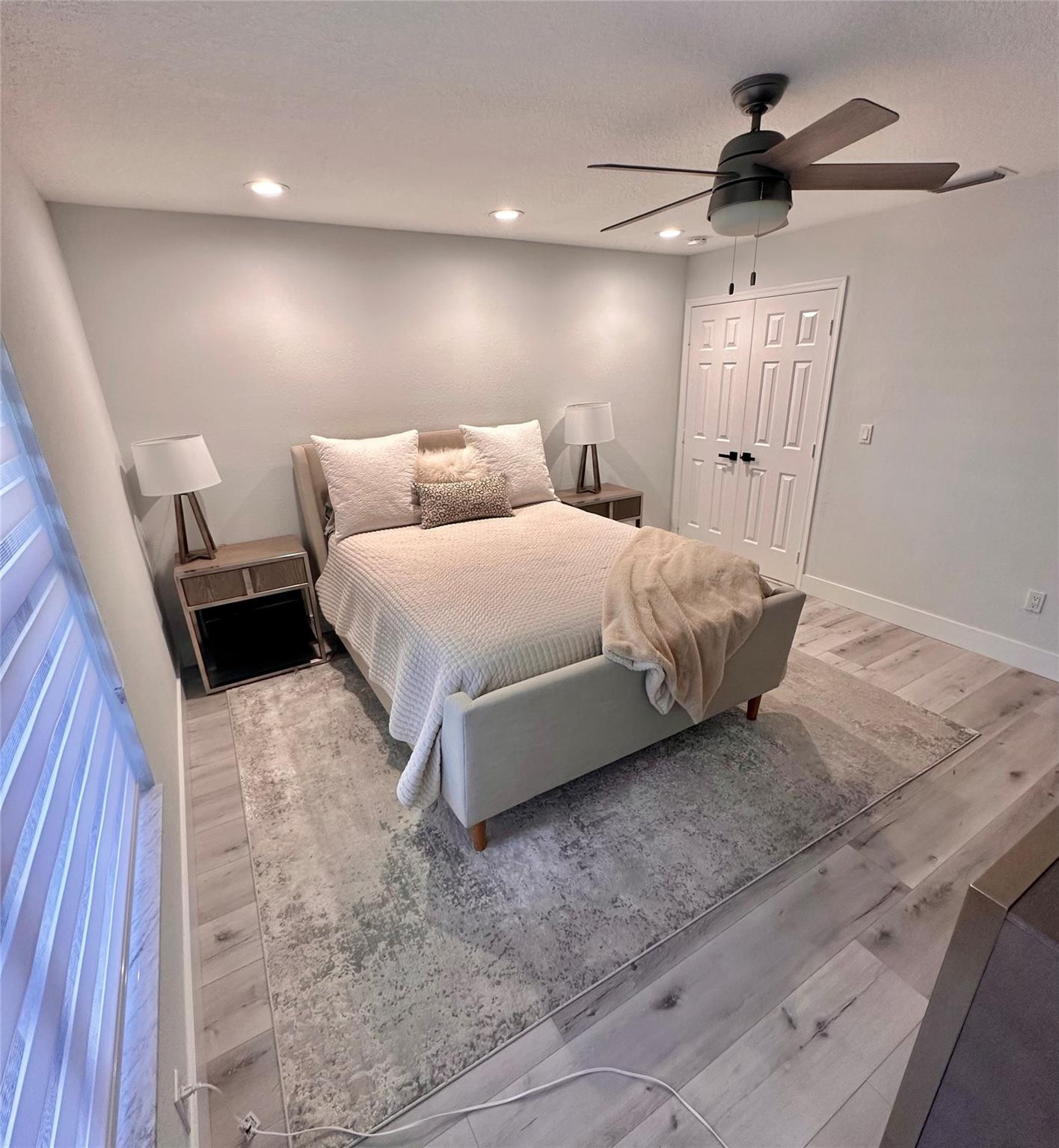 11392 Boca Woods Lane Boca Raton, FL 33428 - Photo 17 of 26 a spacious bedroom with a bed and a chandelier