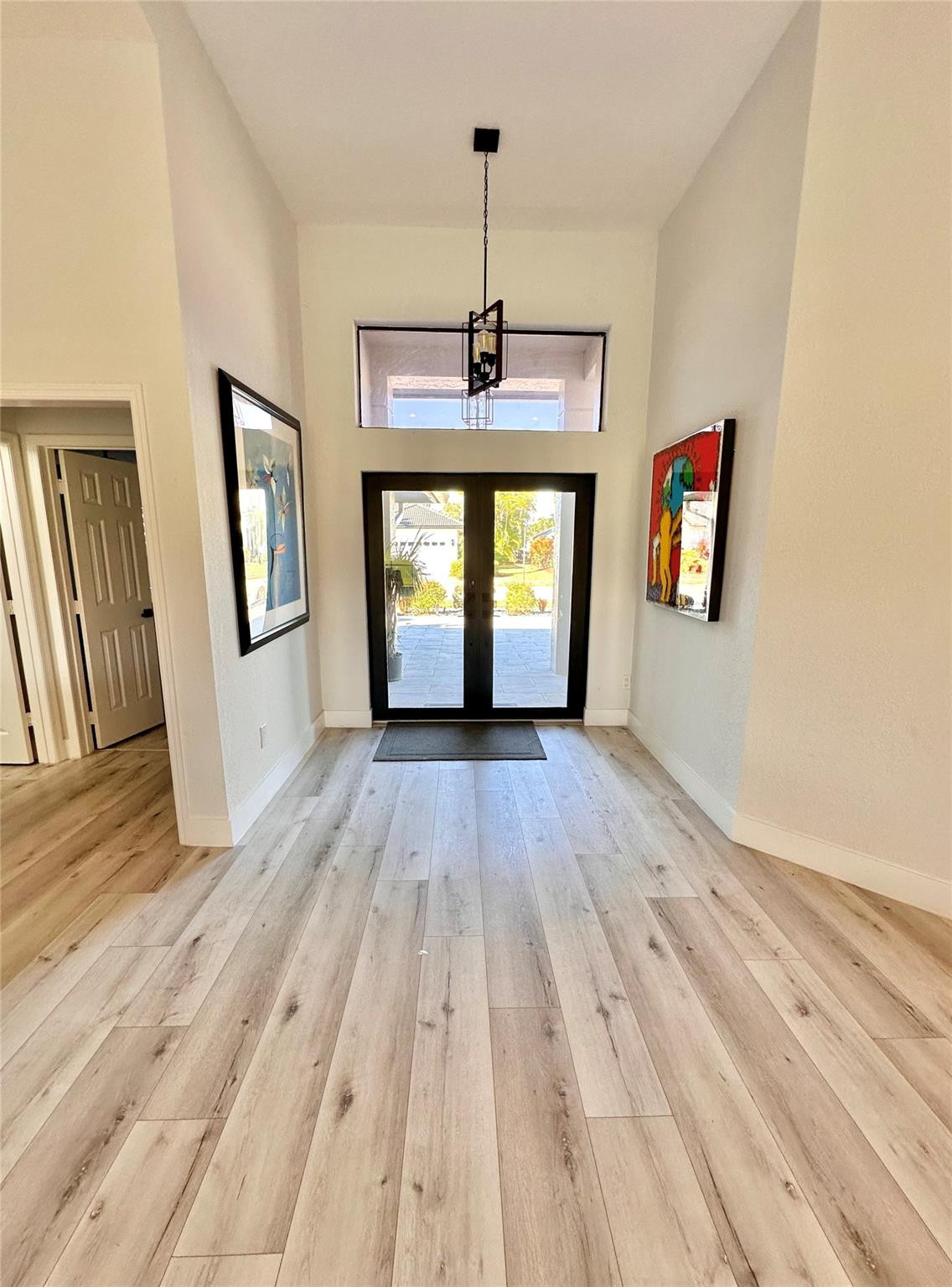 11392 Boca Woods Lane Boca Raton, FL 33428 - Photo 3 of 26 a view of a room with wooden floor and windows