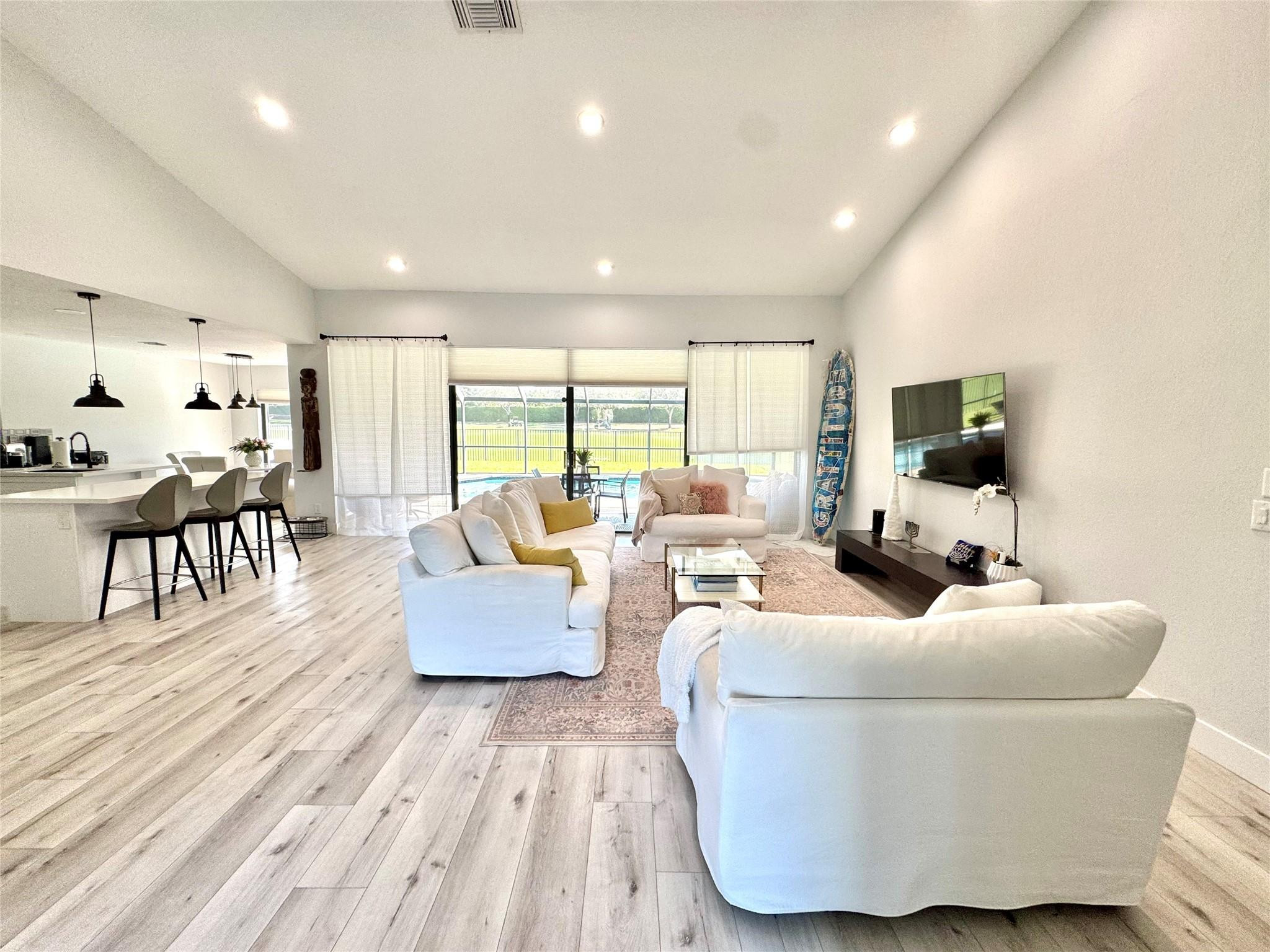 11392 Boca Woods Lane Boca Raton, FL 33428 - Photo 4 of 26 a living room with furniture and a flat screen tv