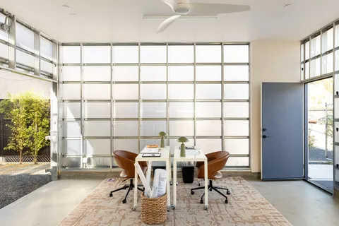 a living room with furniture and a floor to ceiling window