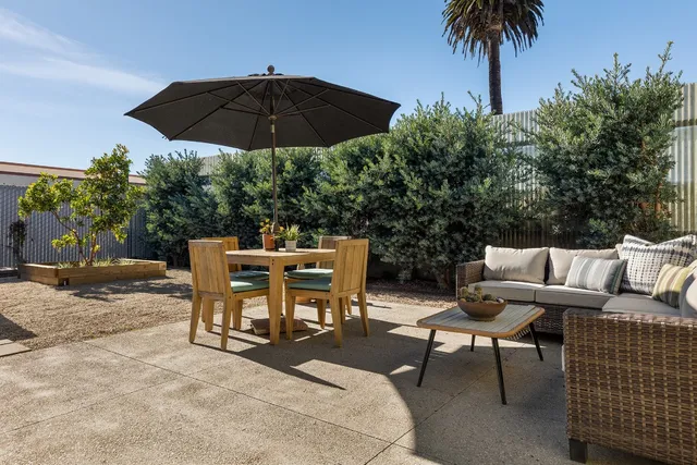 a view of a house with a small yard and plants