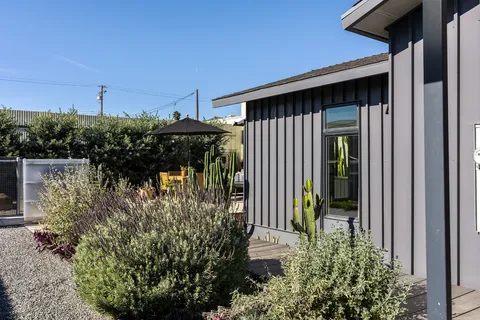a backyard of a house with table and chairs
