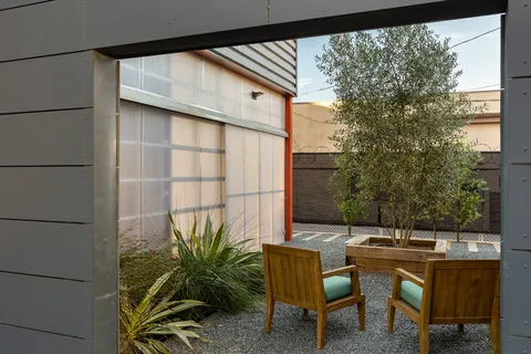 a backyard of a house with table and chairs