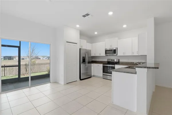 a kitchen with stainless steel appliances a refrigerator sink and cabinets