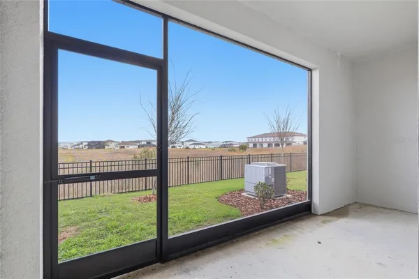 an empty room with cabinet and mirrors