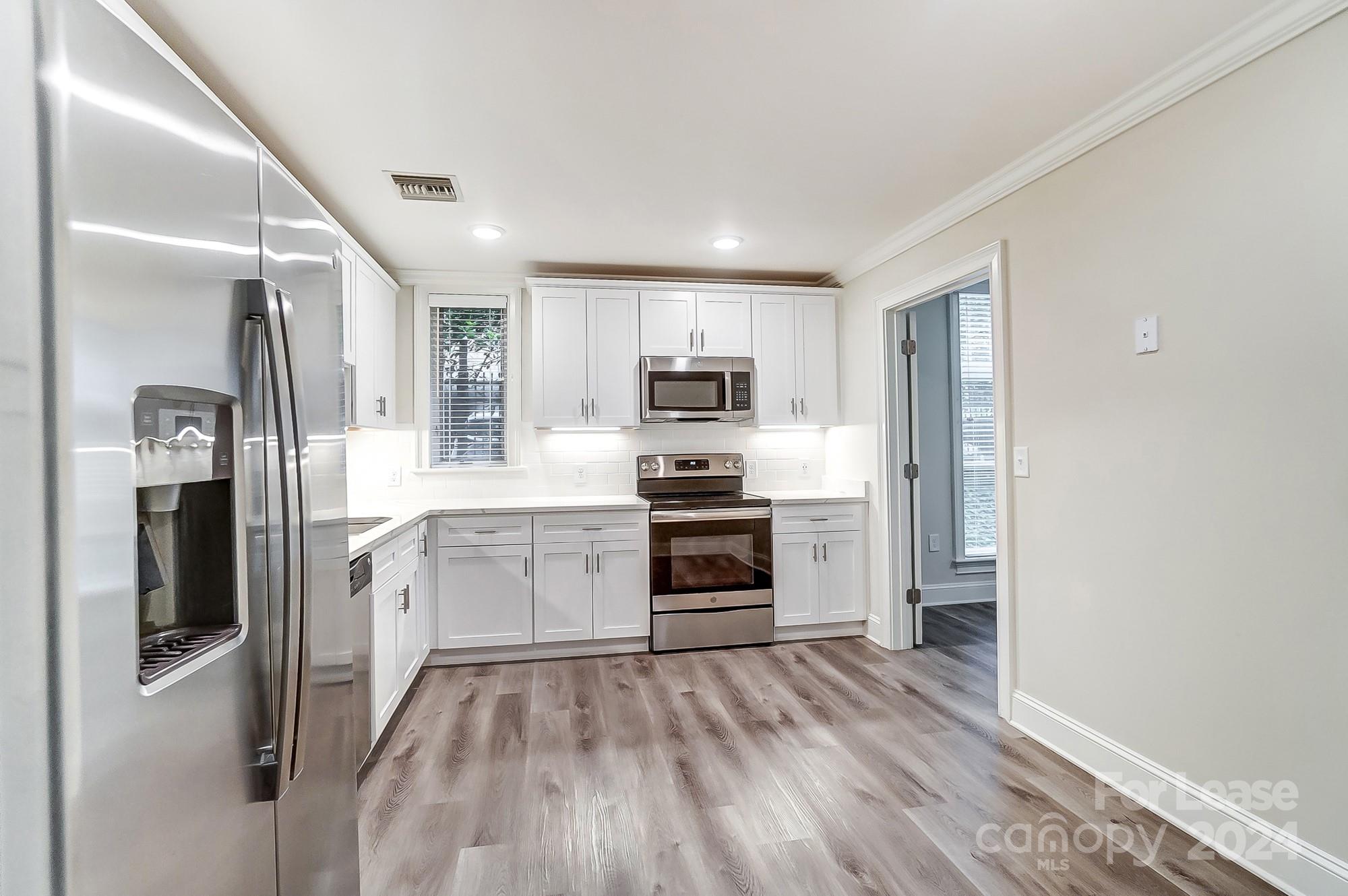 1301 Queens Road, Unit 205 Charlotte, NC 28207 - Photo 16 of 23 a kitchen with a refrigerator stove and sink