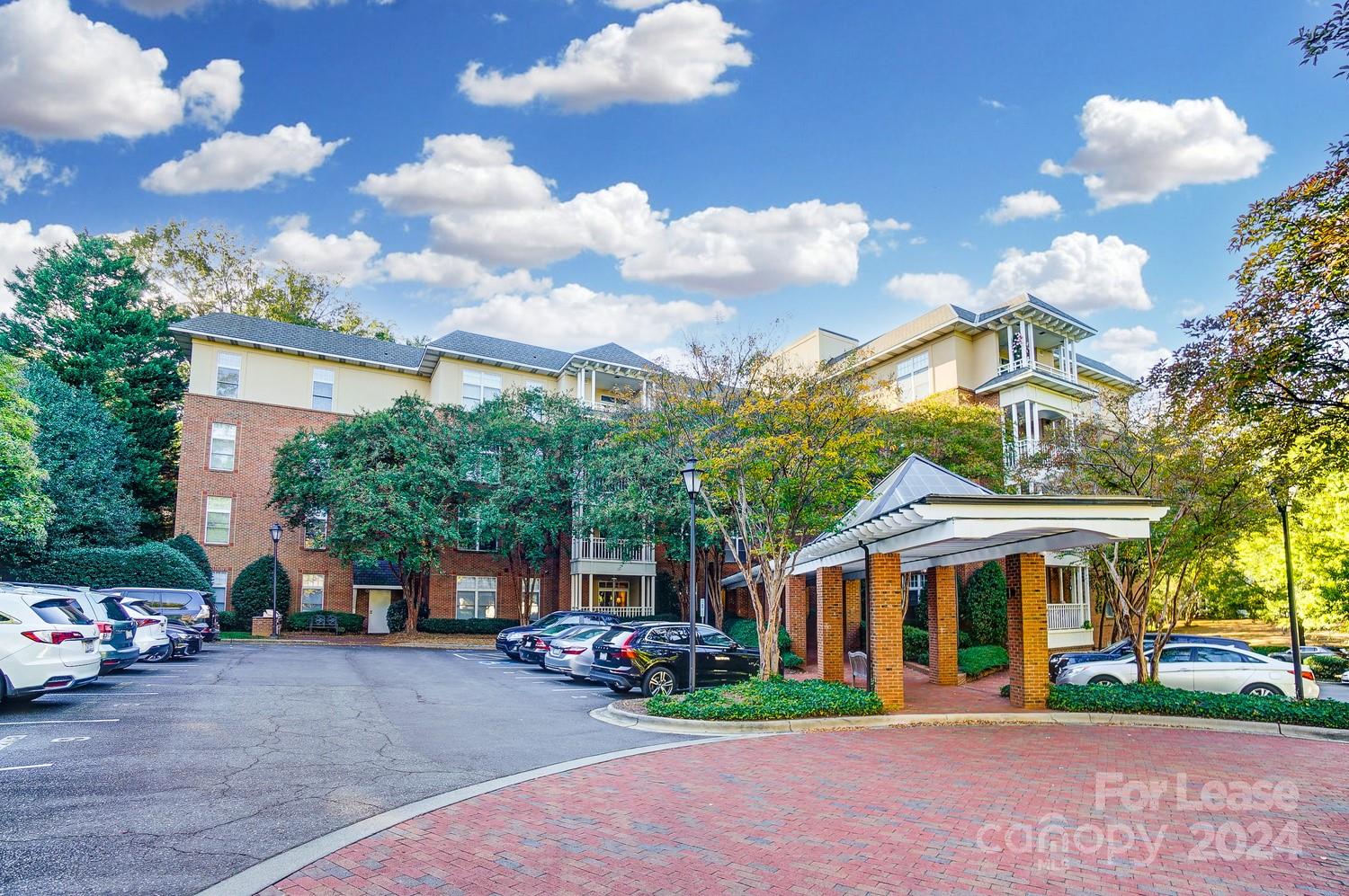 1301 Queens Road, Unit 205 Charlotte, NC 28207 - Photo 3 of 23 a view of a parked cars in front of a building