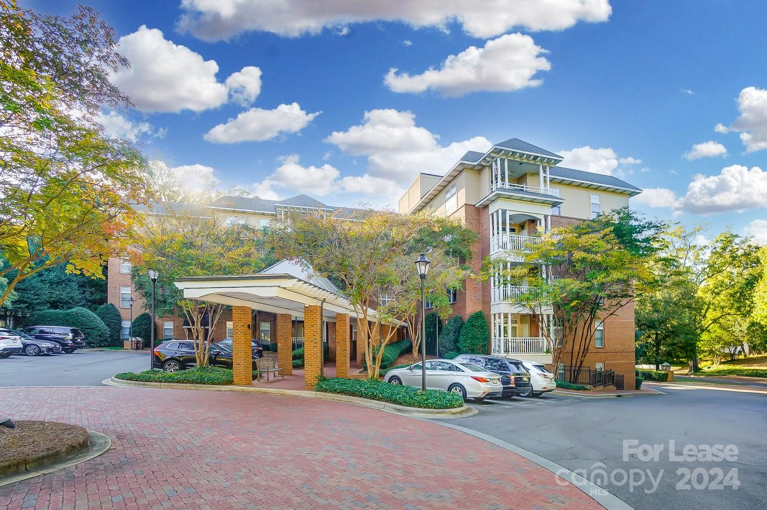 1301 Queens Road, Unit 205 Charlotte, NC 28207 - Photo 4 of 23 a front view of a house with a garden and pathway