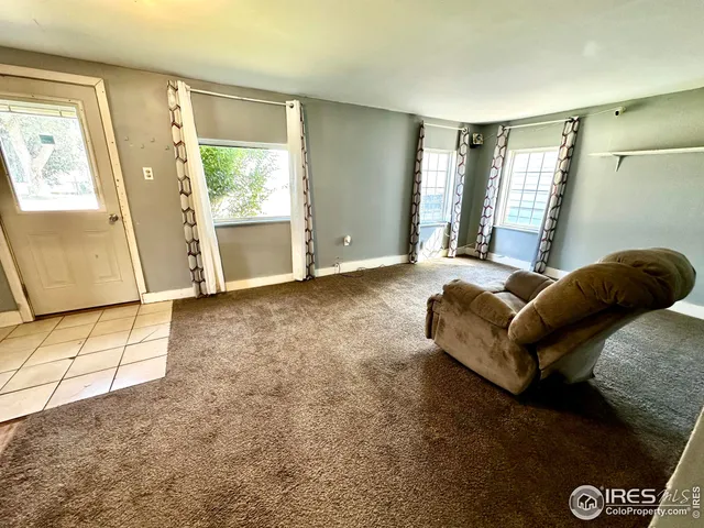 a spacious bedroom with a bed and wooden floor