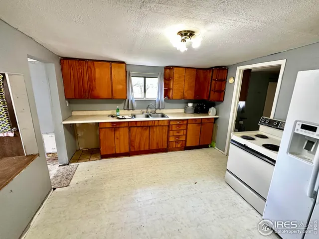 a large bed sitting in a room next to a window