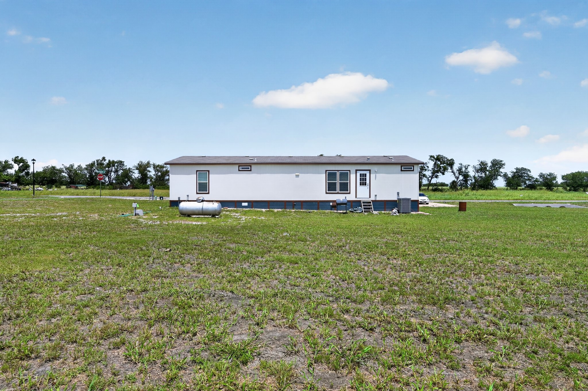 1134 Switchgrass Road Salado, TX 76571 - Photo 27 of 28 A manufactured home sits on a vast, verdant lot, presenting a serene rural living opportunity.