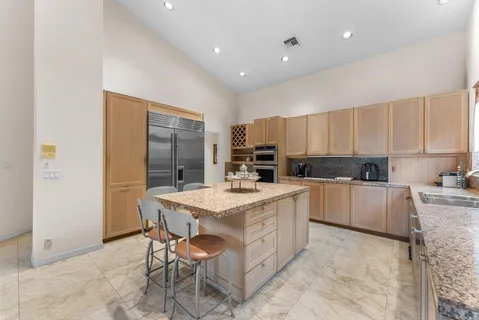 a living room with furniture and large windows