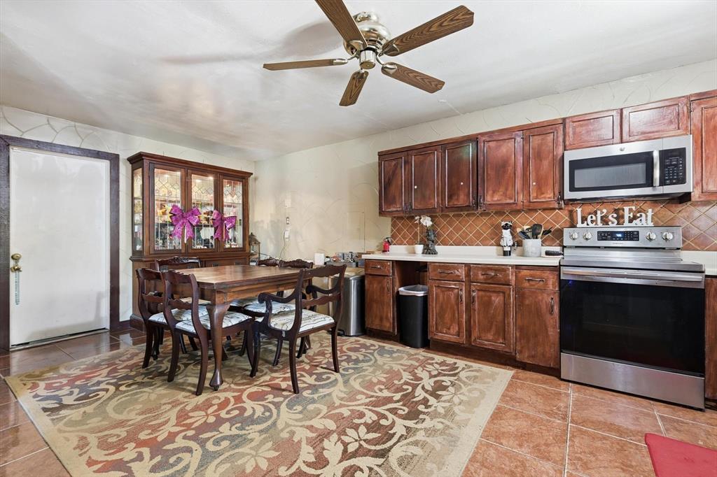 6317 Locust Street Rowlett, TX 75089 - Photo 11 of 40 a kitchen with a dining table and chairs