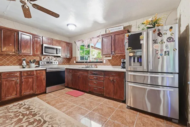 a kitchen with a sink window and cabinets