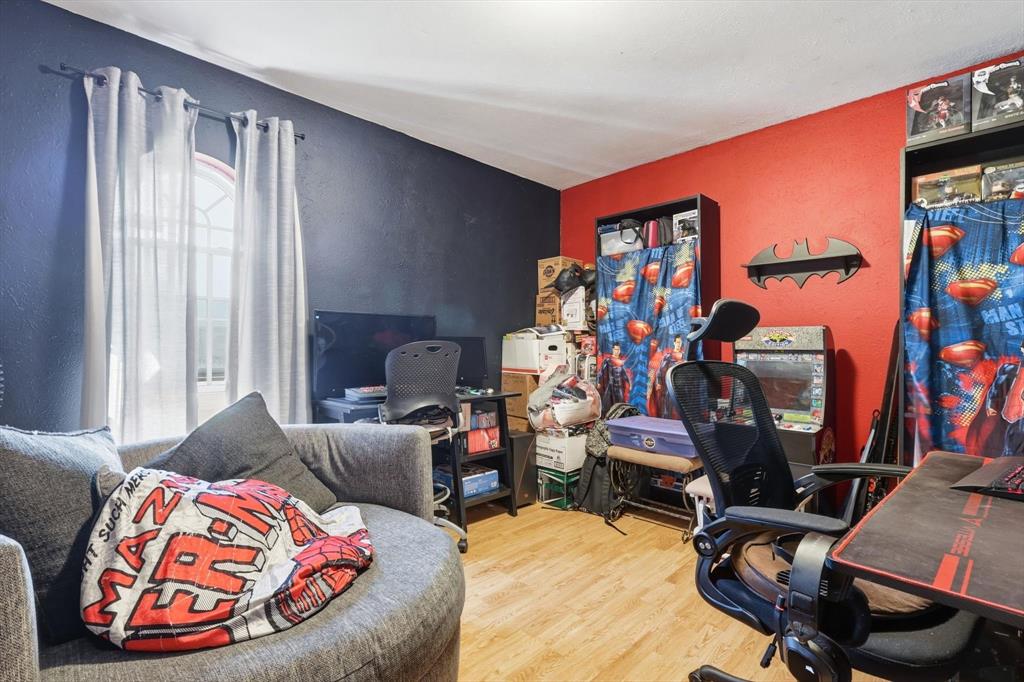 6317 Locust Street Rowlett, TX 75089 - Photo 20 of 40 a living room with furniture a flat screen tv and a window