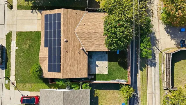 an aerial view of a house with a yard