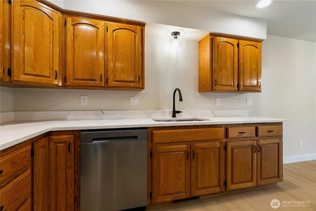 a kitchen with stainless steel appliances granite countertop a sink and cabinets