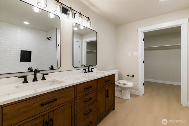 a bathroom with a double vanity sink double and mirror