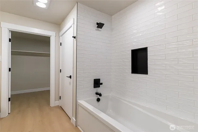 a bathroom with a bathtub and shower