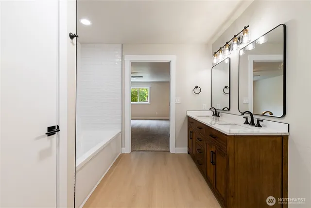 a spacious bathroom with a double vanity sink and mirror