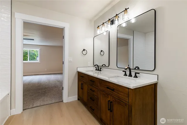a bathroom with a double vanity sink and mirror