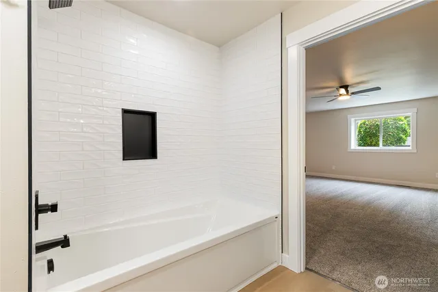 a bathroom with a bathtub and a shower