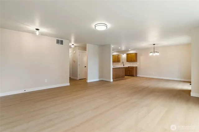 an empty room with a bathroom and a sink