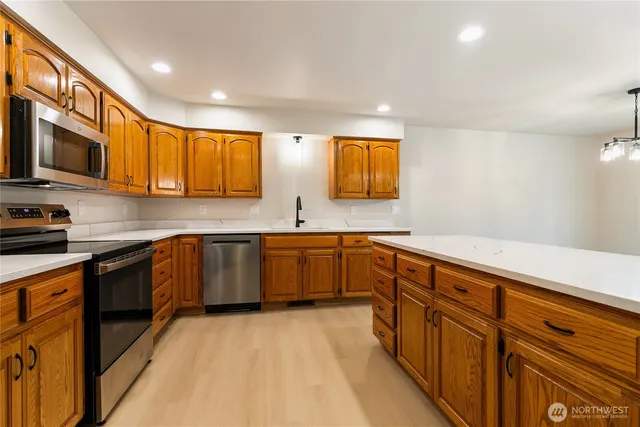 a kitchen with stainless steel appliances granite countertop a sink and cabinets