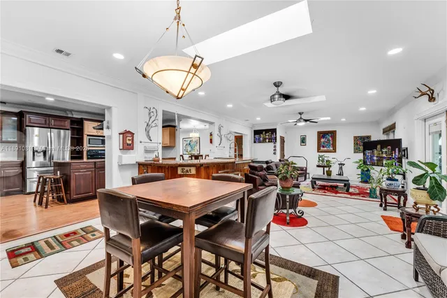 a room with lots of tables a dining table and chairs